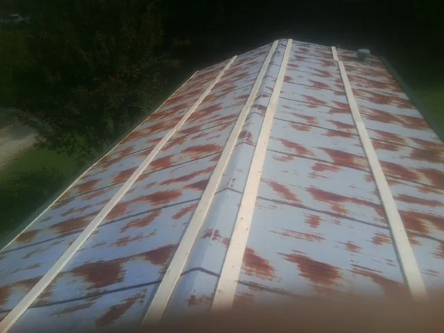 Rusted metal roof panels with new wood purlins before replacement — Storm Damage Roof Repair in Phil Campbell by Roofing Brothers